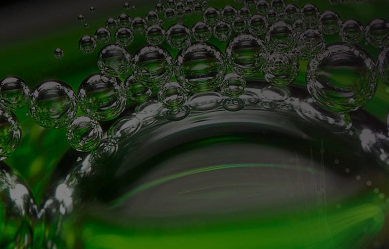 Green abstract background with reflective bubbles.