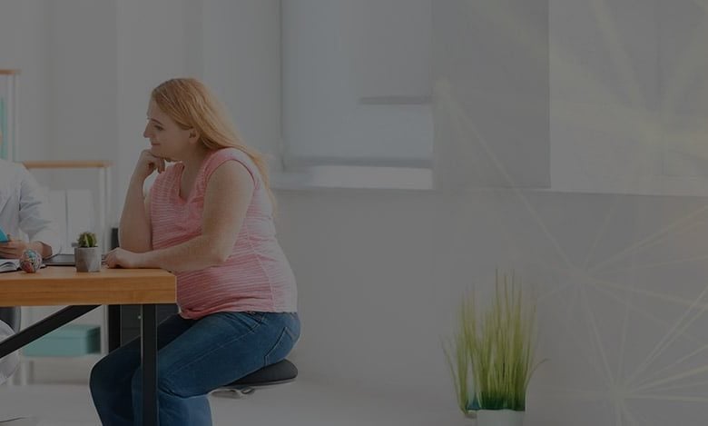 Doctor discussing weight loss plan with a patient in an office.