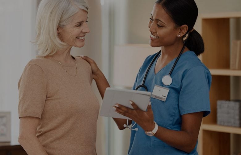 Nurse discussing health with a patient in a clinic setting.